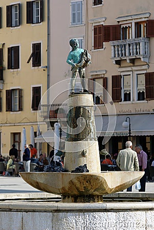 Boy fountain with a fish statue in Rovinj, Croatia Editorial Stock Photo