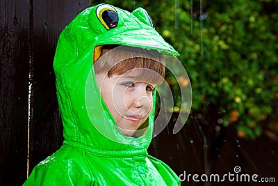 Boy Frog Raincoat With Rain Spattering Stock Photo