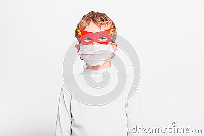 A boy with a fun superhero mask to protect himself from the viral infections of the disease Stock Photo