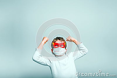 A boy with a fun superhero mask to protect himself from the viral infections of the disease Stock Photo