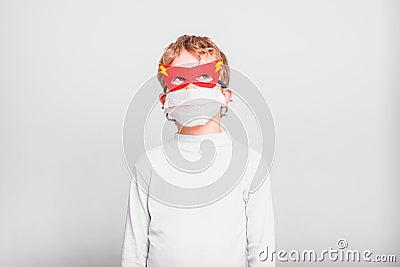 A boy with a fun superhero mask to protect himself from the viral infections of the disease Stock Photo