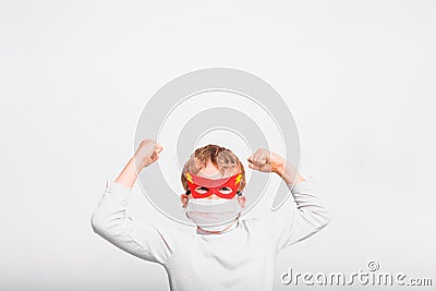 A boy with a fun superhero mask to protect himself from the viral infections of the disease Stock Photo