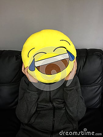 Boy with funny emoticon face Stock Photo