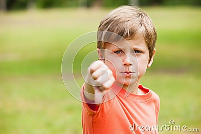 Boy gesturing thumbs down at the park Stock Photo