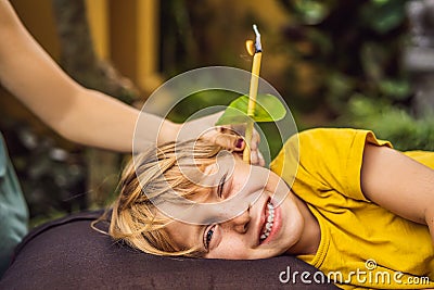 The boy gets a procedure with an ear candle, children`s ears health, good hearing, earwax Stock Photo