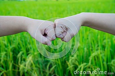 Boy and girl bumping hands to fist Stock Photo