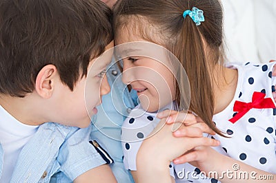 Boy and girl bumping heads against each other Stock Photo