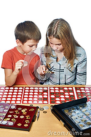 Boy and girl are considering coin collection isolated Stock Photo