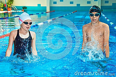 Boy and a girl dive in the pool Stock Photo