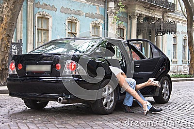 Boy and girl hide in the car Stock Photo