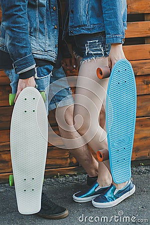 Boy and girl hold skateboards in hands Stock Photo