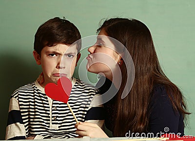 Boy and girl hold two red cardboard heart Stock Photo