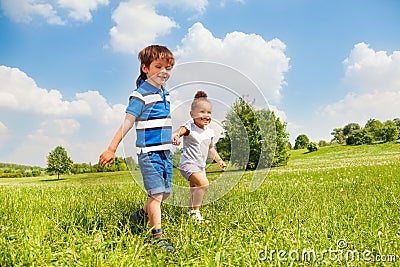 Boy and girl holding hands playing together Stock Photo