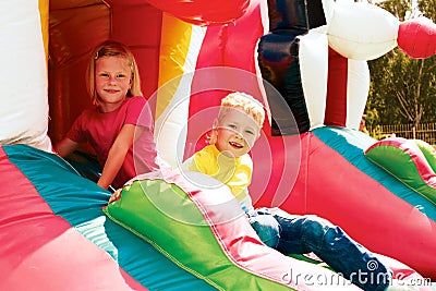 Boy and girl playing in the amusement park Stock Photo