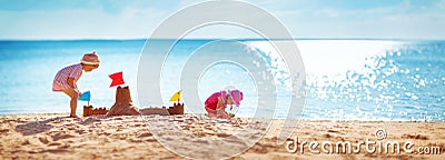 Boy and girl playing on the beach Stock Photo