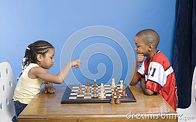 Boy and girl playing chess Stock Photo