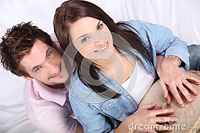 Boy and girl playing djembe together inside Stock Photo
