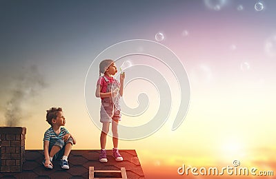 Boy and girl playing on the roof Stock Photo