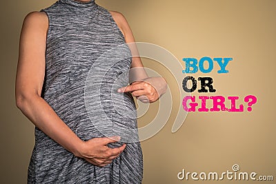 Boy or girl. Pregnant woman on light background Stock Photo