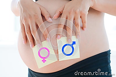 Boy or girl question dilemma on pregnancy belly Stock Photo