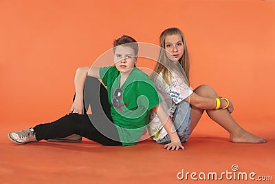 Boy and girl sitting back-to-back Stock Photo