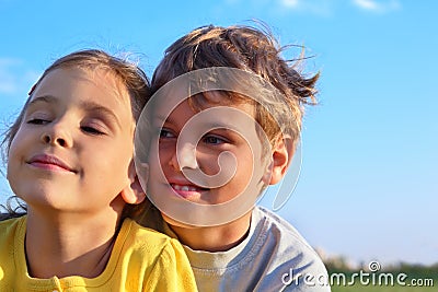 Boy and girl smile and look toward Stock Photo