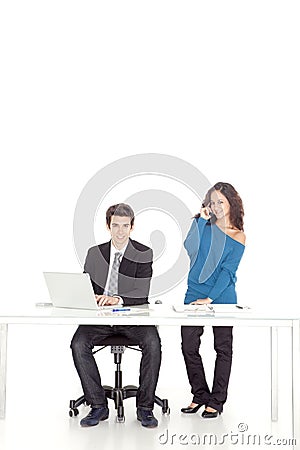 Boy and girl smiling while talking to phone Stock Photo