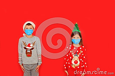 A boy and a girl wearing respiratory masks keep their distance Stock Photo