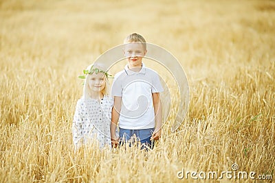 boy and girl in wheat field Stock Photo