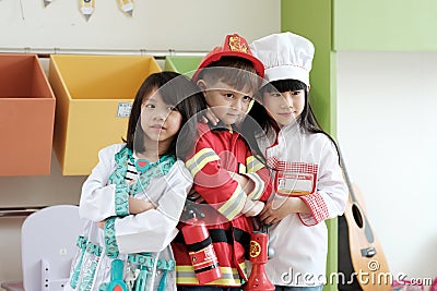 Boy and girls playing as fireman police, doctor and chef occupation in kindergarten class, kid occupation, education concept Stock Photo