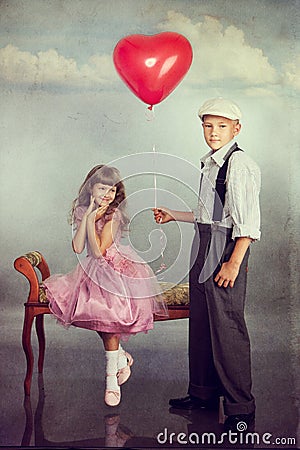 The boy gives a balloon to the girl Stock Photo