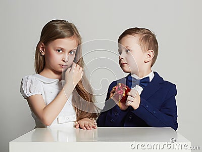 Boy gives a girl gift.little beautiful couple.kids Stock Photo