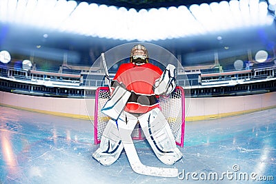 Boy goaltender under the lights of hockey stadium Stock Photo