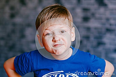 The boy grimaces in front of the camera Stock Photo