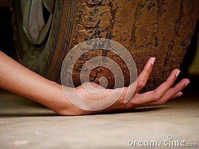 Boy hand presented in front of car tire Stock Photo