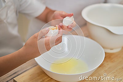 Boy hands separating the egg white from the yolk for the pie Stock Photo