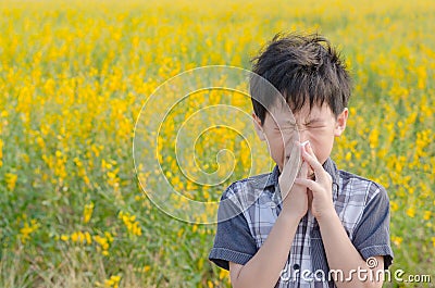 Boy has allergies from flower pollen Stock Photo