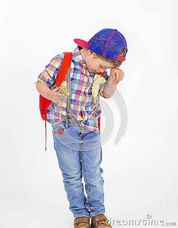 Boy with hat eats fruit in a funny way Stock Photo