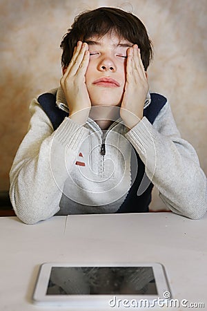 Boy with headache and tired eyes Stock Photo