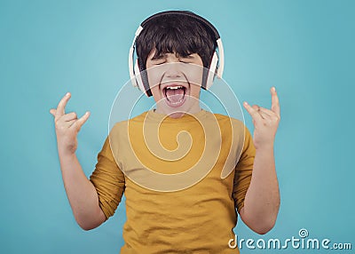 Boy with headphones showing rock sigh Stock Photo