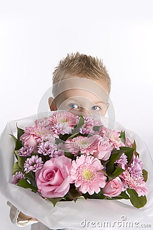 Boy is hiding behind a bouquet of flowers Stock Photo