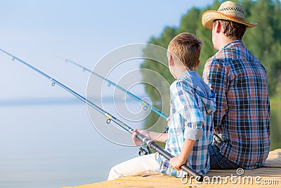 Boy and his father fishing togethe Stock Photo