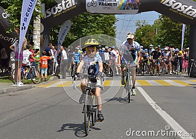 Boy with his father riding bicycles, competing for Road Grand Prix event, a high-speed circuit race in Ploiesti-Romania Editorial Stock Photo