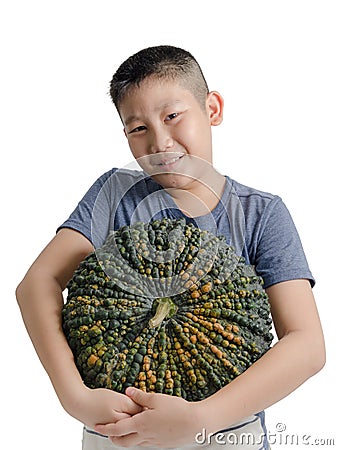 Boy holding big pumpking on white background.. Stock Photo