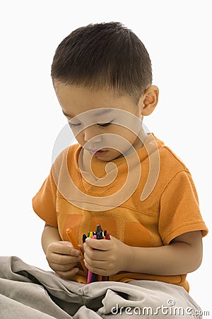 Boy holding crayons. Stock Photo