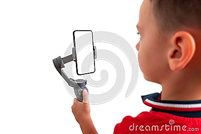 Boy holding gimbal with smart phone in vertical position. Isoalted background and display for mockup Stock Photo