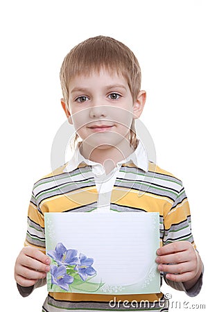 Boy holding sheet of paper with blue flowers Stock Photo