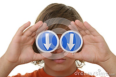 Boy holds before arrow eyes specifying downwards Stock Photo