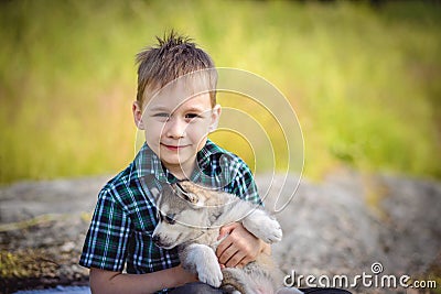 The boy with husky puppy Stock Photo