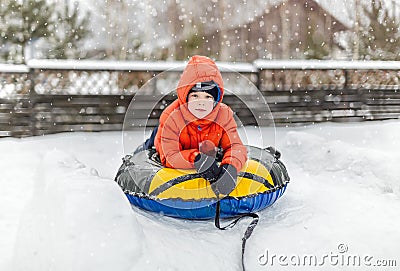 Boy with the inflatable sledge Stock Photo